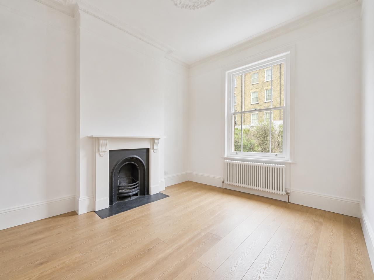 The same living room after painting, new flooring and a deep clean